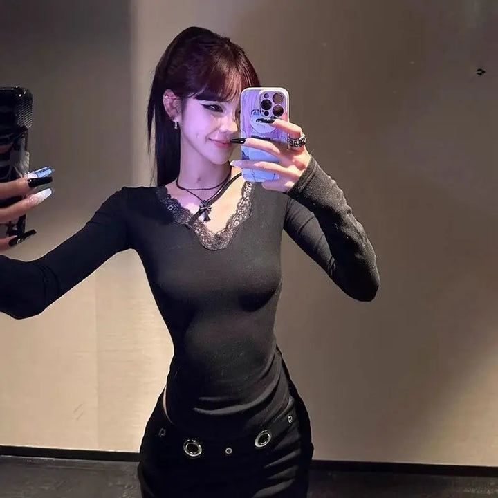 Black fitted long-sleeve crop top with V-neck trim