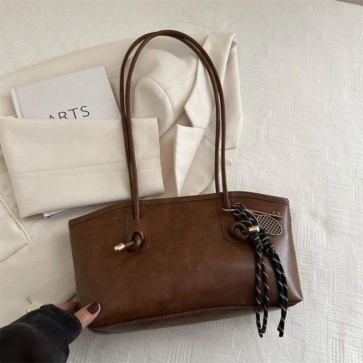 Large PU leather crossbody tote handbag, brown with zipper pull and woven charm