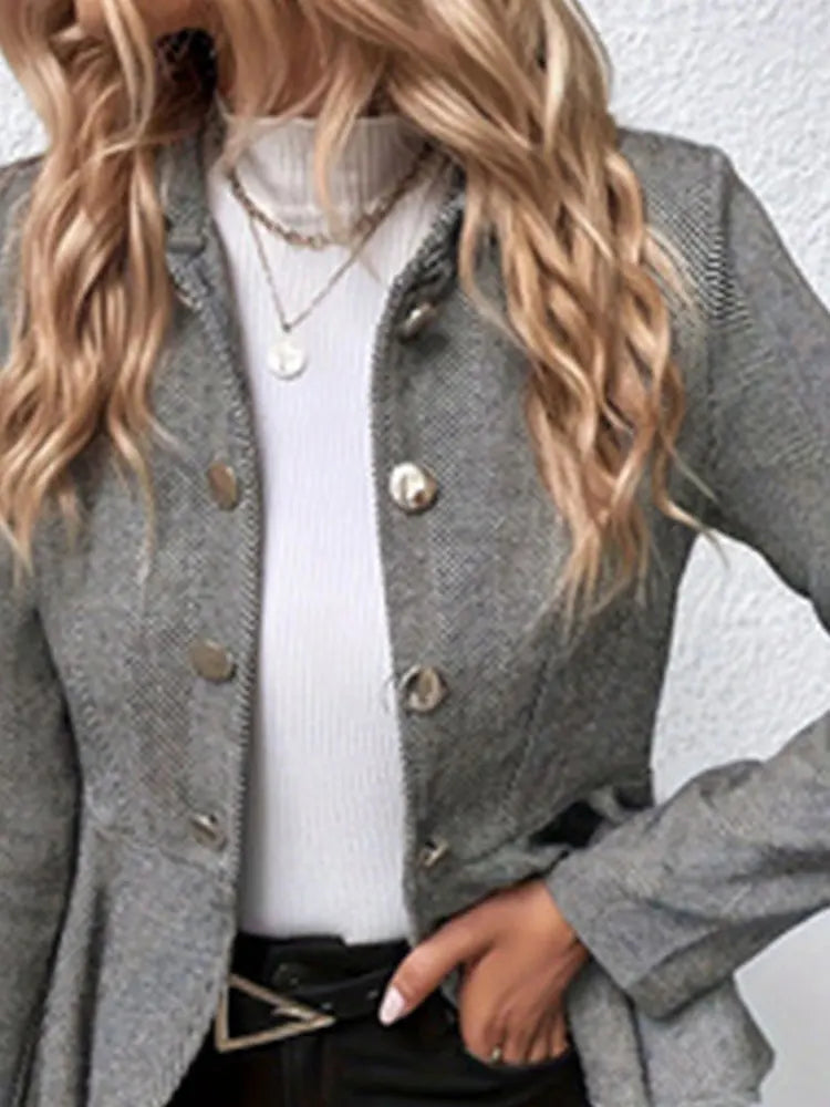 Gray double-breasted trench coat with peplum hem, gold buttons and notched collar.
