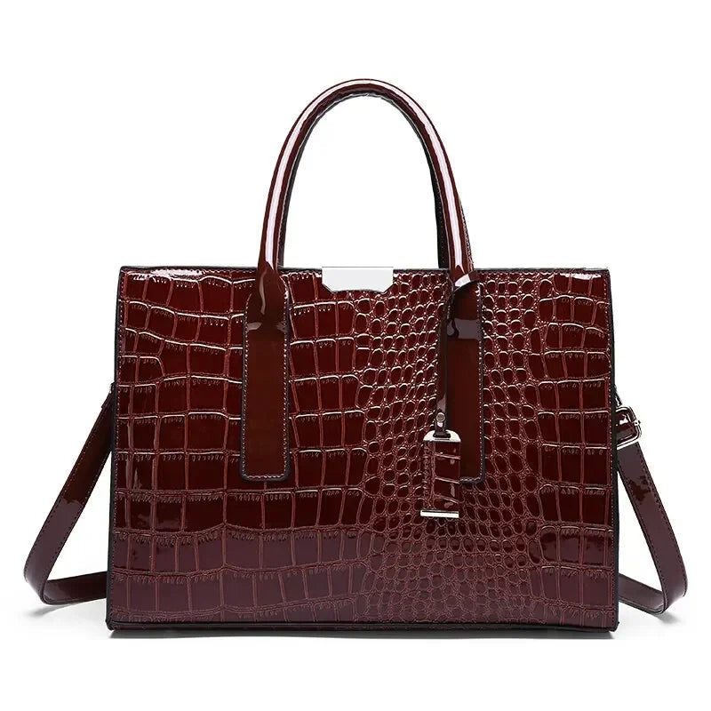 Crocodile-pattern leather tote handbag with top handles and shoulder strap, deep brown.