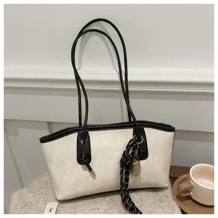 Cream and black PU leather tote handbag with top handles and braided crossbody strap