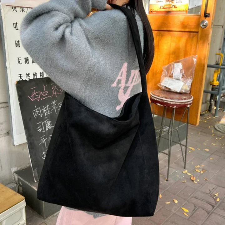 Black suede-look underarm tote bag with open top and short handles
