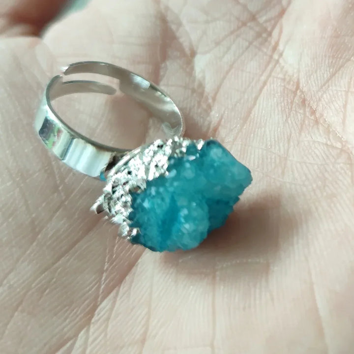 Silver ring with a blue stone on a hand