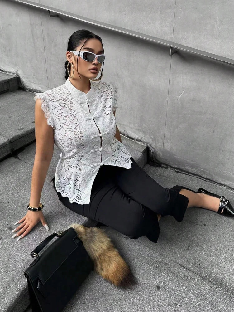 White sleeveless lace blouse with peplum hem and frog-button front