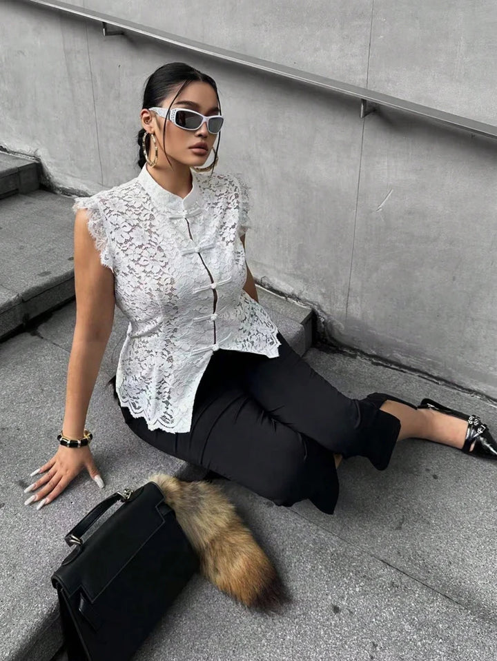 White sleeveless lace blouse with peplum hem and frog-button front