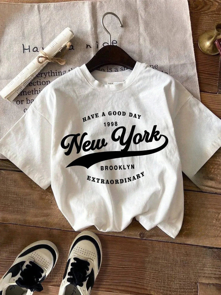 White plus size graphic tee with “Have a Good Day” New York Brooklyn design