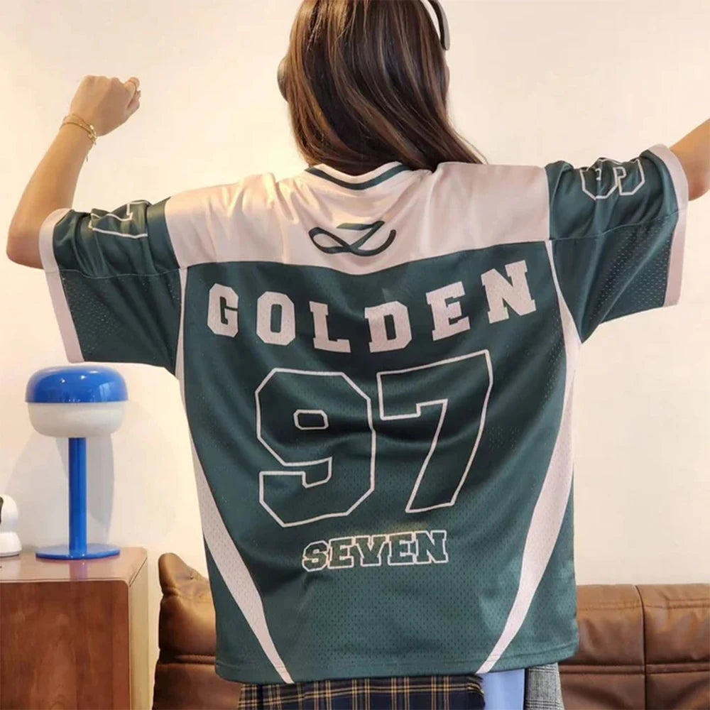 Person wearing a green and white sports jersey with 'GOLDEN 97 SEVEN' text in a casual setting.