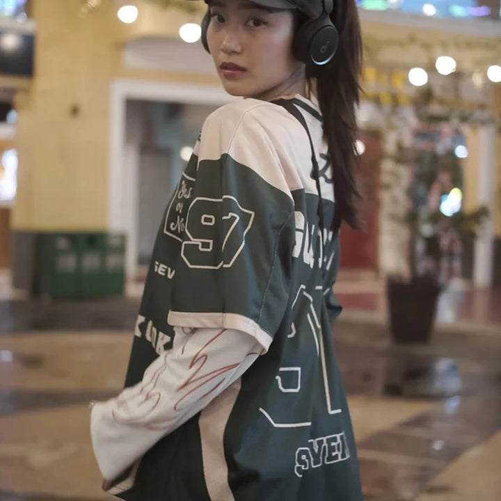 Person wearing a green and beige sports jersey with numbers in an indoor setting
