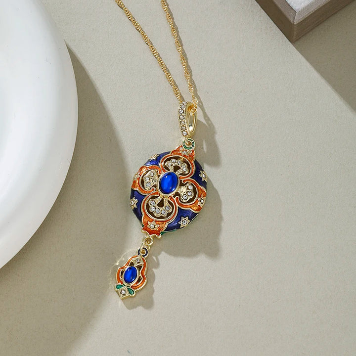 Decorative necklace with blue and gold pendant on a neutral background