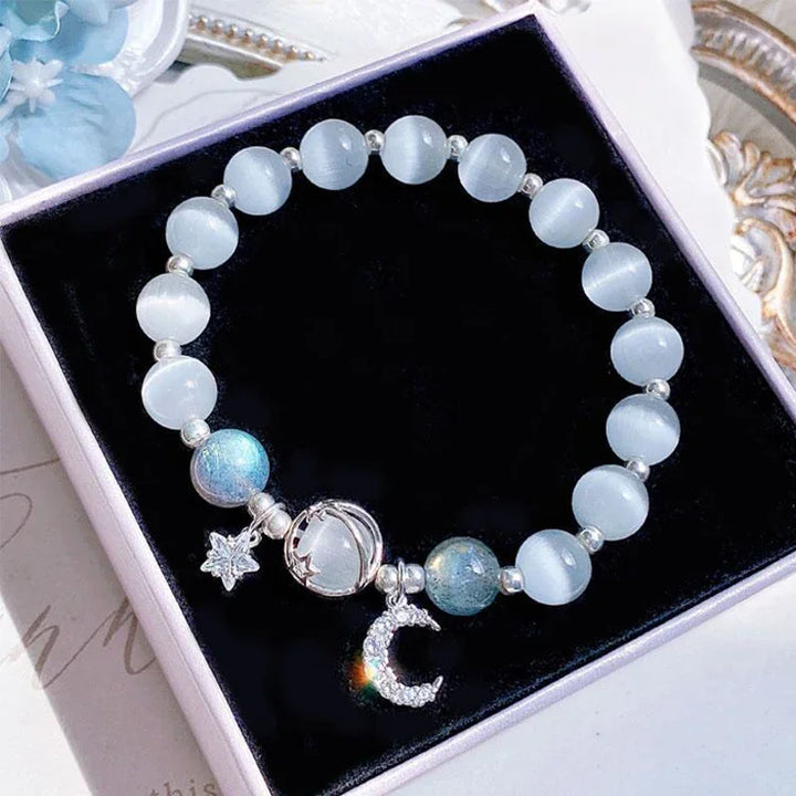Light blue bead elastic bracelet with star and crescent charms in jewelry box