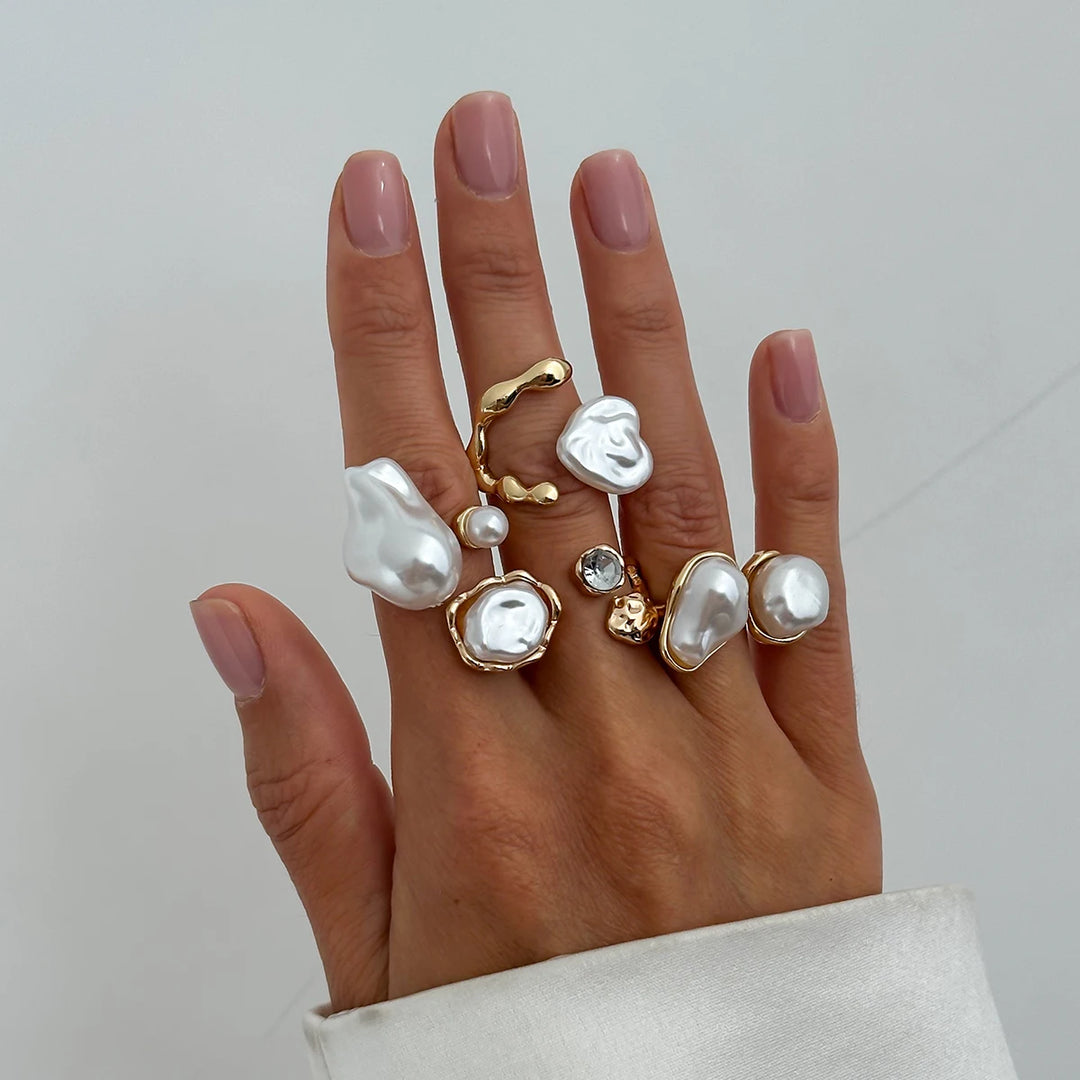 Women's open pearl rings with gold-tone frames and white faux pearls, on hand