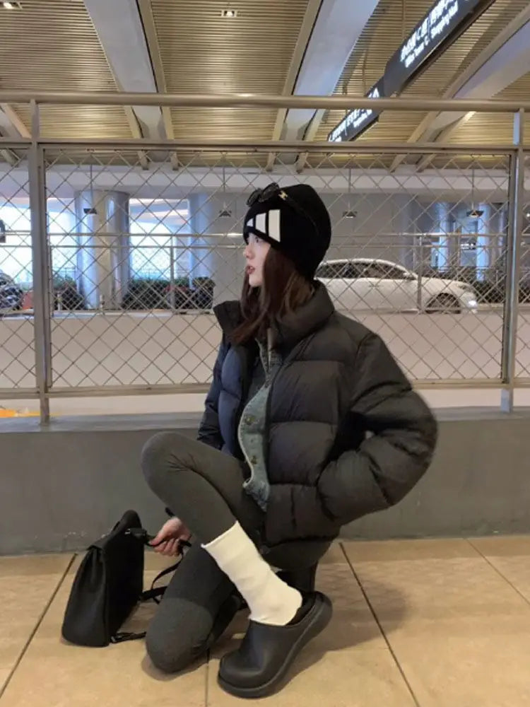 Women wearing black thick padded puffer coat.
