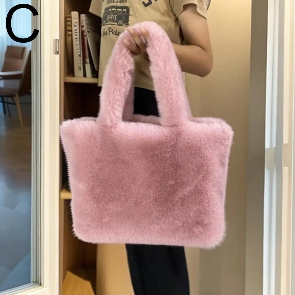 Person holding a fluffy pink handbag indoors.