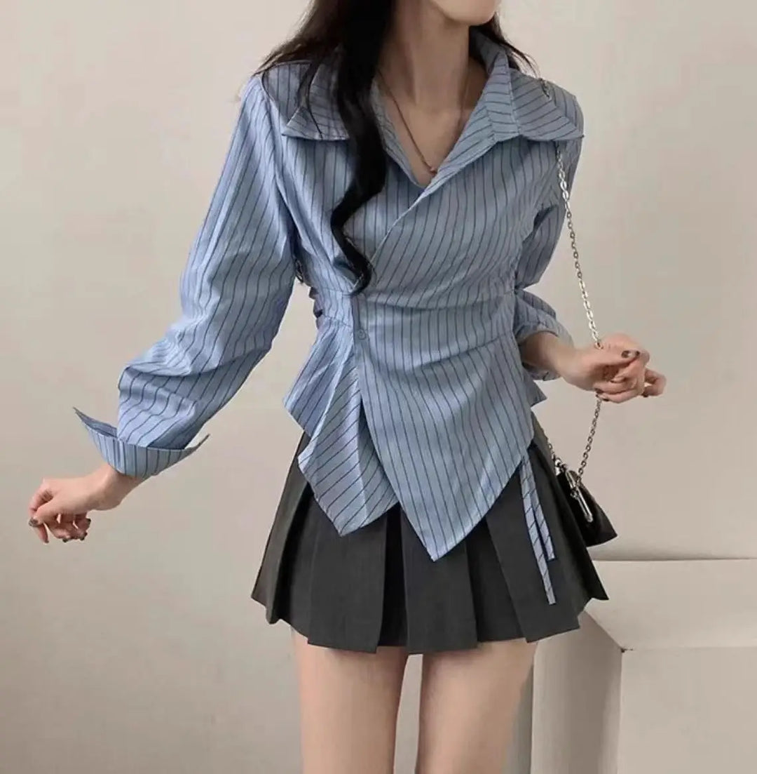 Light blue striped slim-fit blouse with pointed collar and asymmetric hem