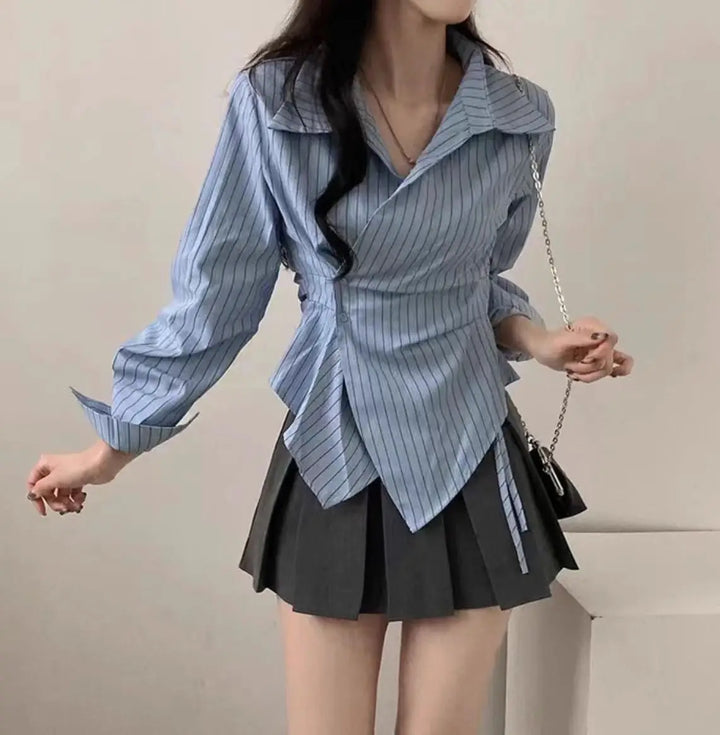 Light blue striped slim-fit blouse with pointed collar and asymmetric hem