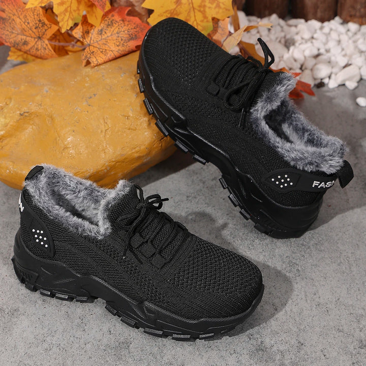 Women’s black knit lace-up snow sneakers with plush gray interior and textured tread sole