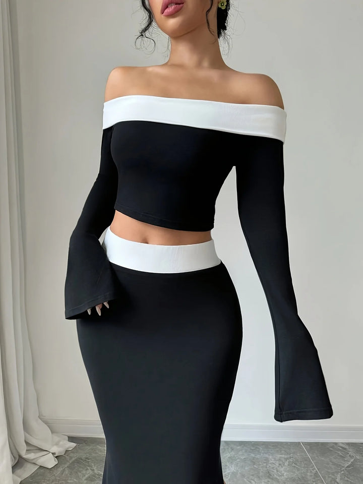 Off-shoulder black crop top with white band and mermaid skirt with center slit