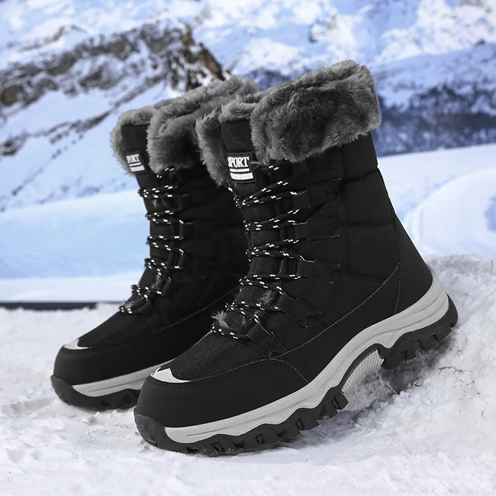 Women’s winter snow boots in black with lace-up front, plush fur cuff, and tread sole.