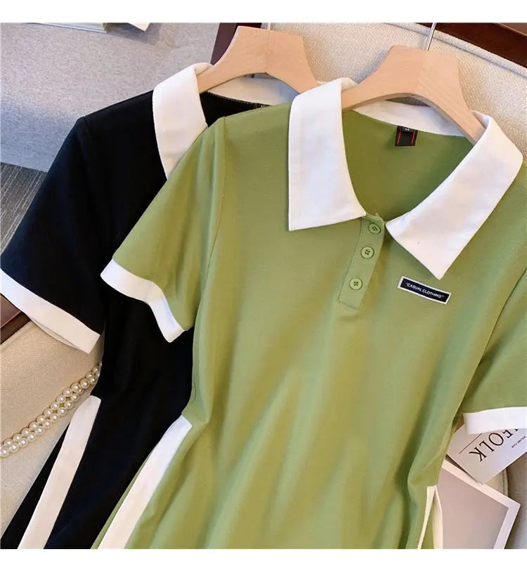 Green and black polo dresses on hangers, white collared polo style