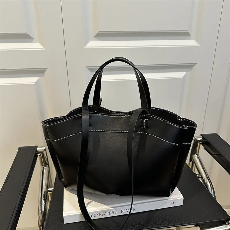 Black handbag on a chair with a white door in the background