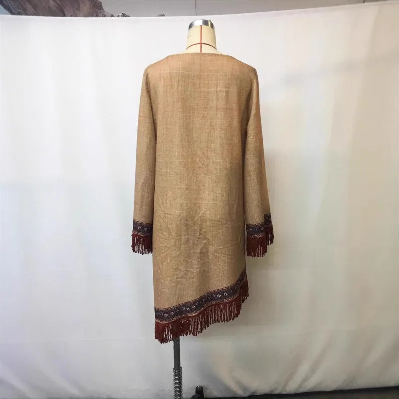 Beige coat with brown trim and fringes on a mannequin against a white background