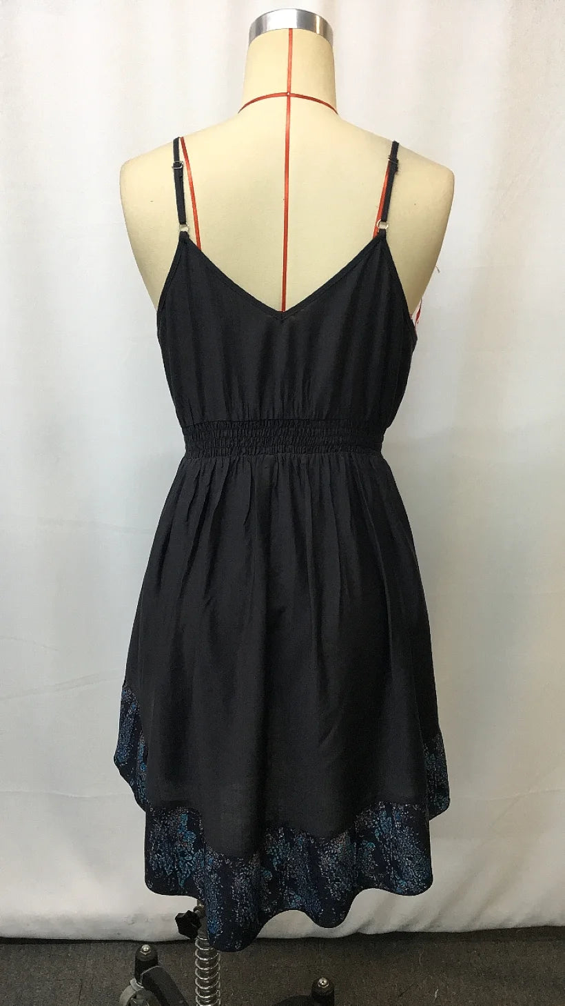 Back view of asymmetrical knee-length hippie dress with spaghetti straps and tiered dark hem