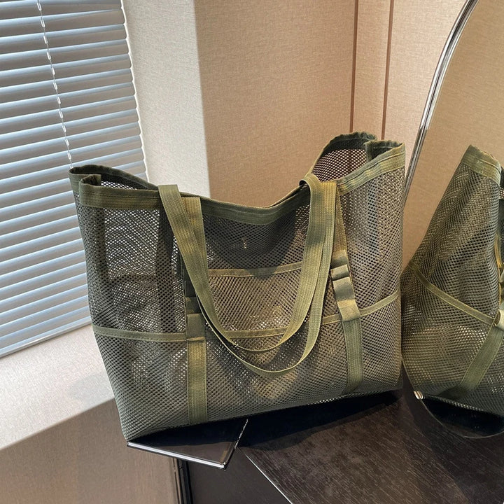 Product description sheet for a mesh shoulder bag, size 55x19x35 cm
