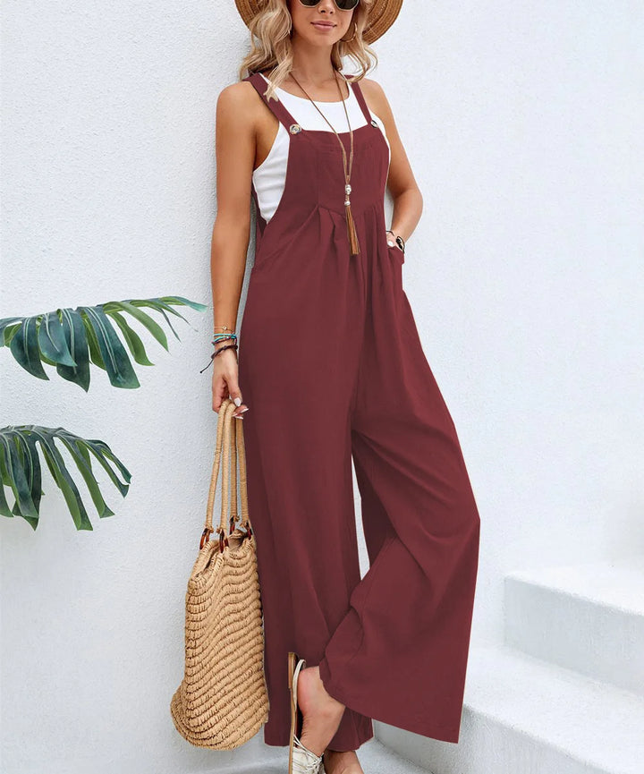 Burgundy sleeveless jumpsuit with adjustable straps and loose wide-leg pants