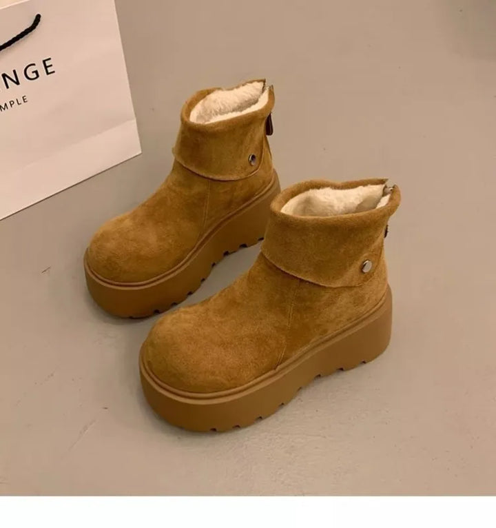 Tan wool-lined ankle boots with button strap, plush lining, and lug platform sole