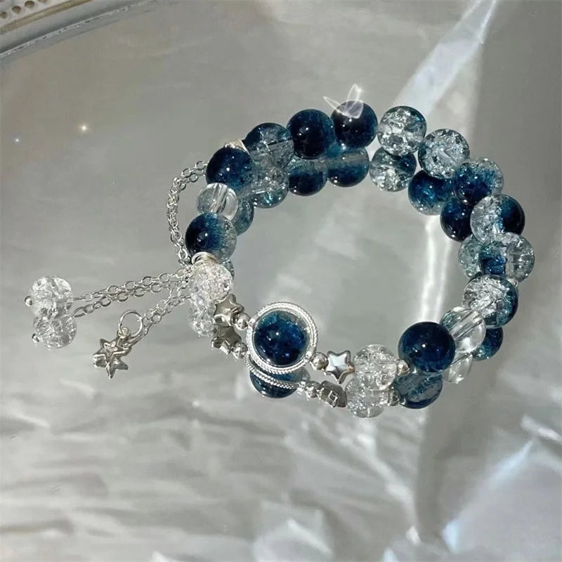 Blue and clear bead charm bracelet with star charm and round center pendant