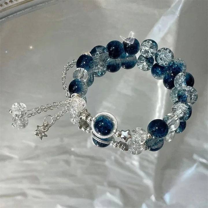 Blue and clear bead charm bracelet with star charm and round center pendant