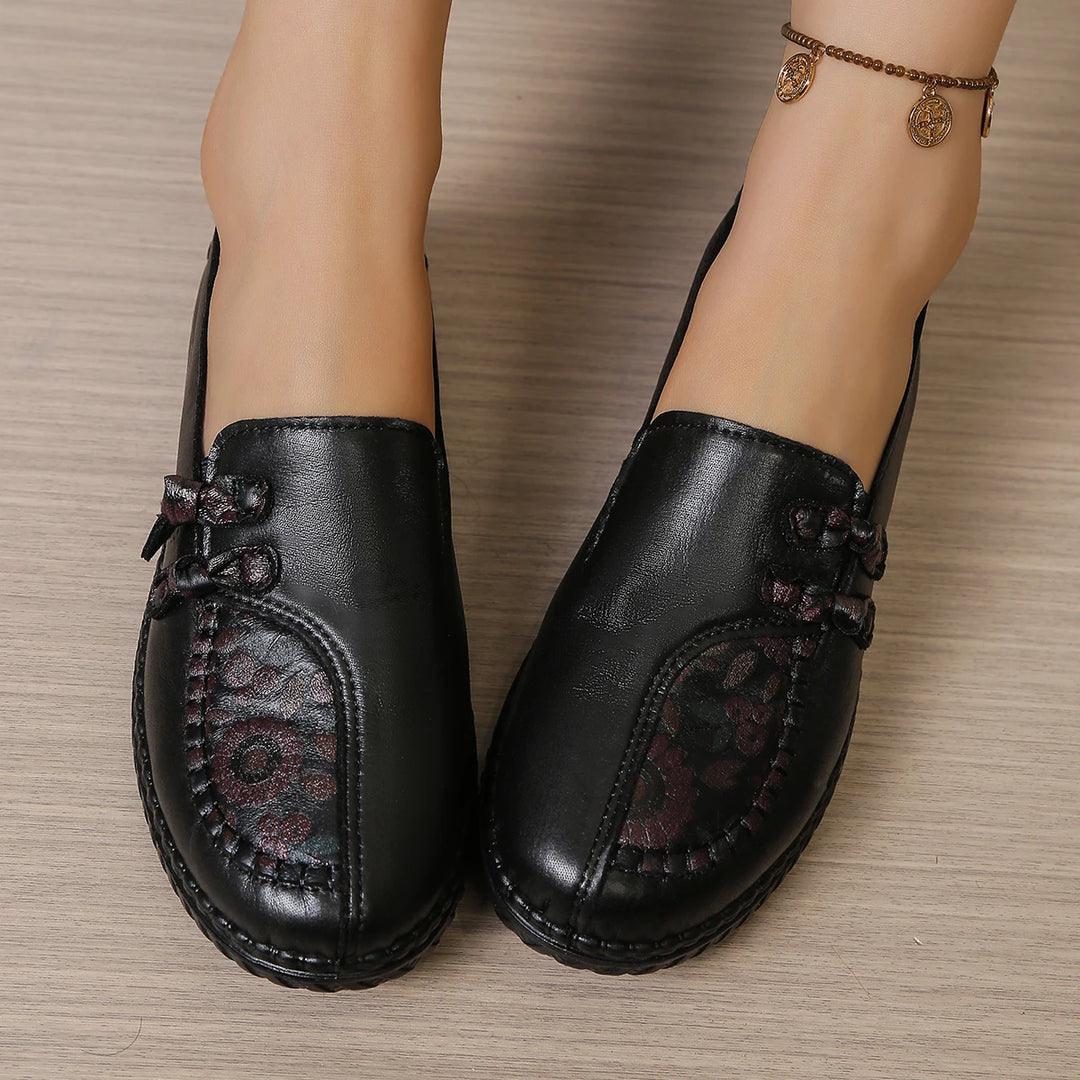 Women’s leather loafers in black, slip-on mule style with butterfly-knot bow on vamp