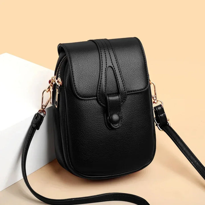Small crossbody handbag in black with flap front and adjustable shoulder strap