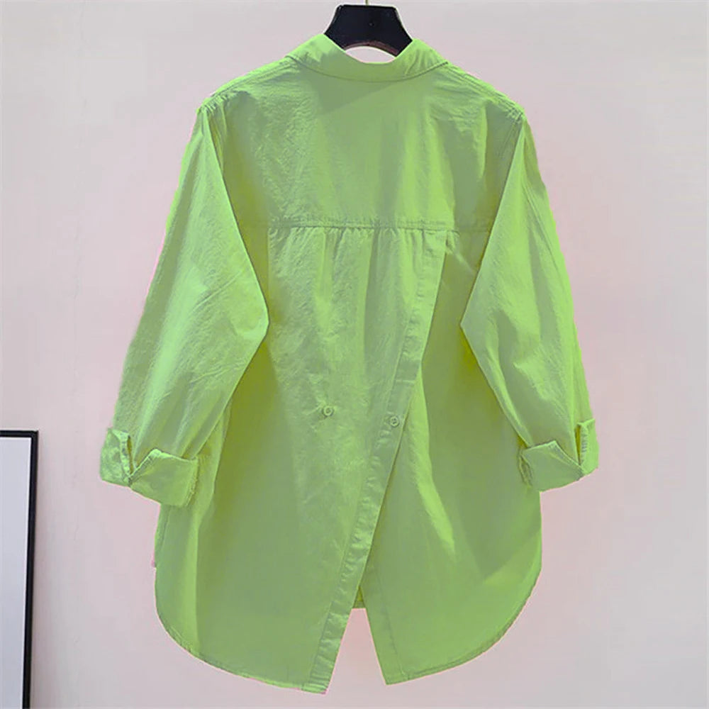 Neon green shirt on a hanger against a plain background