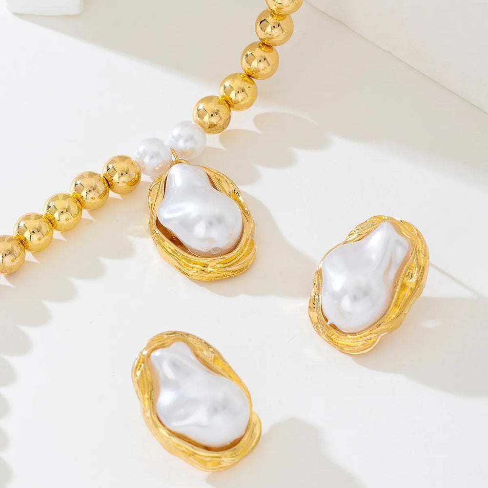 Pearl earrings with gold frames on a white background