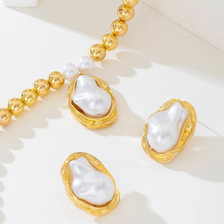 Pearl earrings with gold frames on a white background