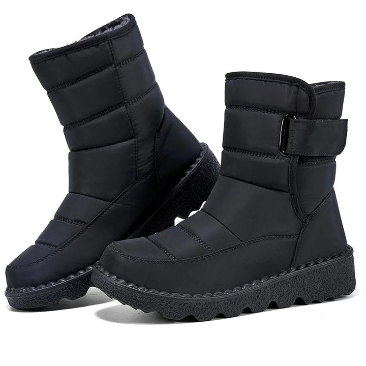 Black winter boots with a strap on a white background