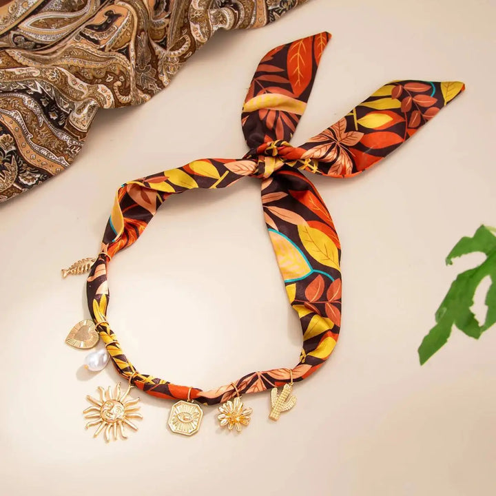 Leaf print scarf choker-style necklace with gold-tone sun and starfish charm accents