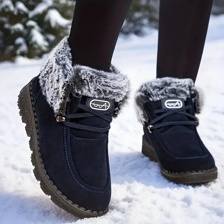 Women's dark lace-up snow boots with faux-fur trim and lug sole
