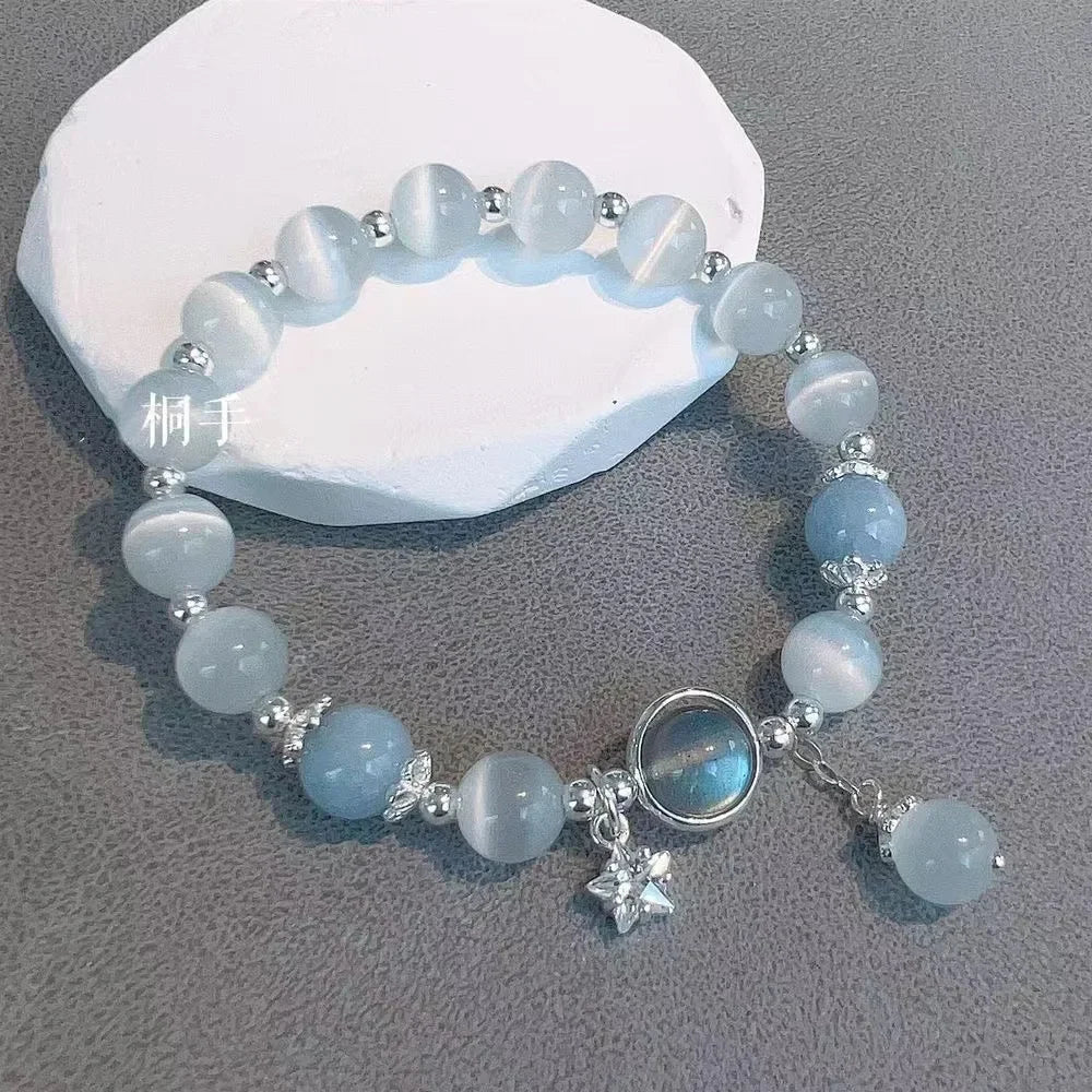 Light blue bead elastic bracelet with star charm and round pendant dangle