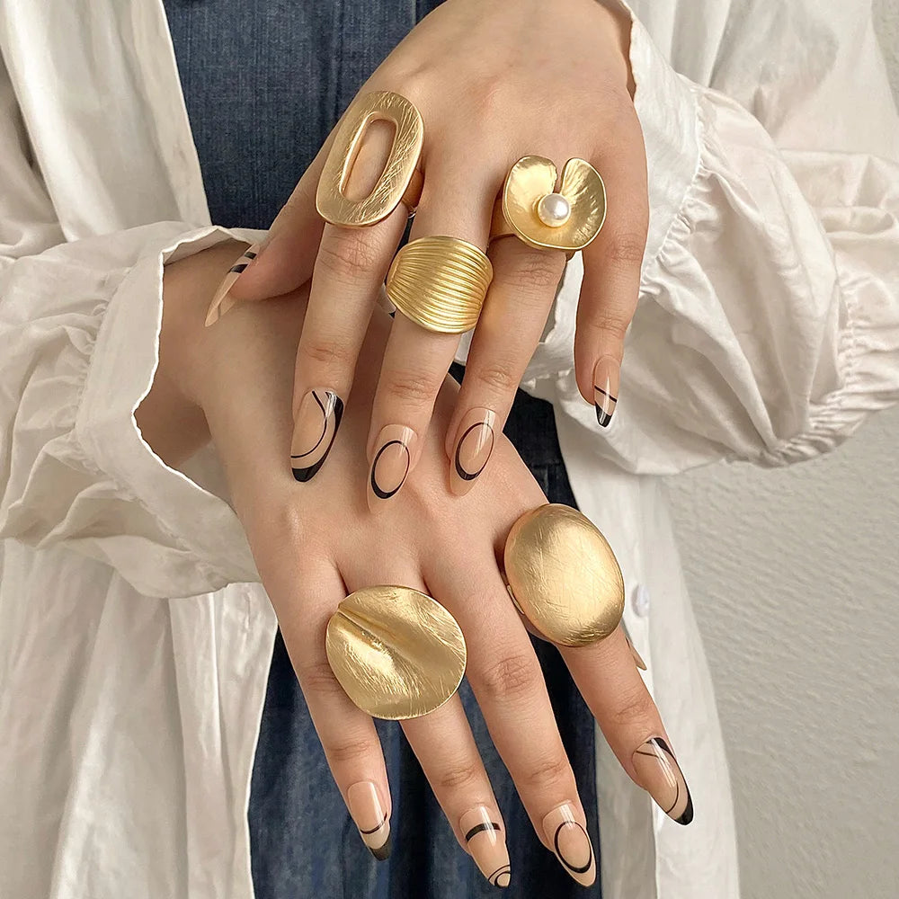 Gold tone chunky mood ring with ridged band and oval textured top