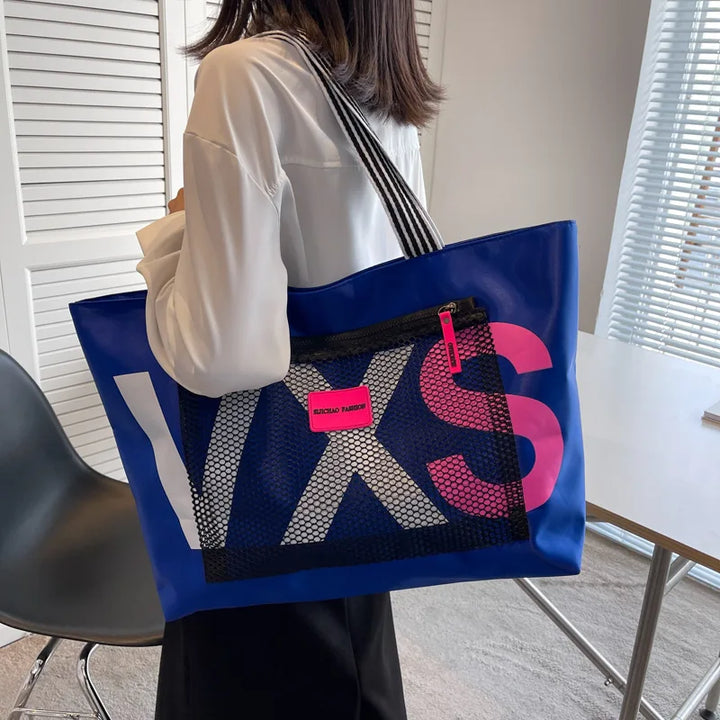 Blue waterproof nylon tote bag with white letter print, pink accents, and laptop interlayer