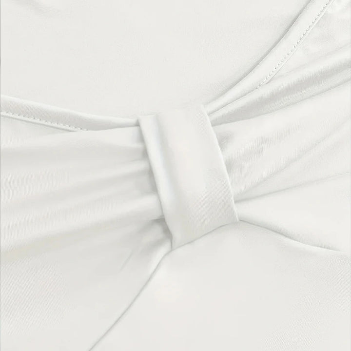 Close-up of white fabric with a bow