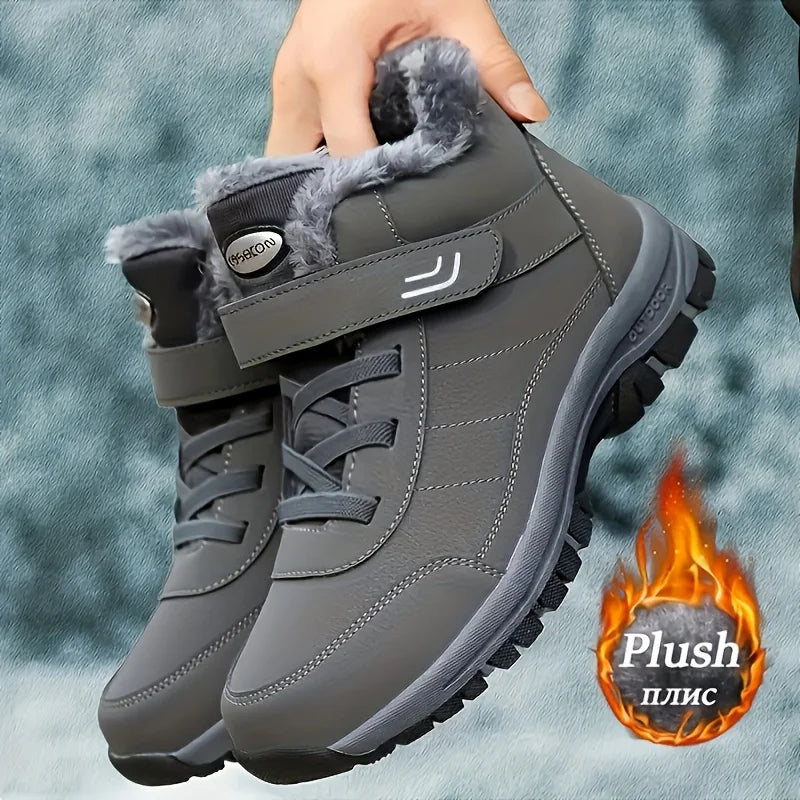 Gray winter snow boots held in hand, plush lining and hook-and-loop strap