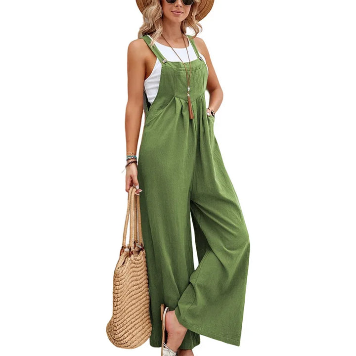 Green sleeveless jumpsuit with adjustable straps, gathered bust, and wide-leg trousers