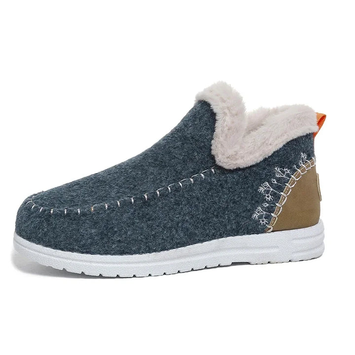 Dark blue felt slip-on ankle snow loafer with white fleece-lined collar and white sole
