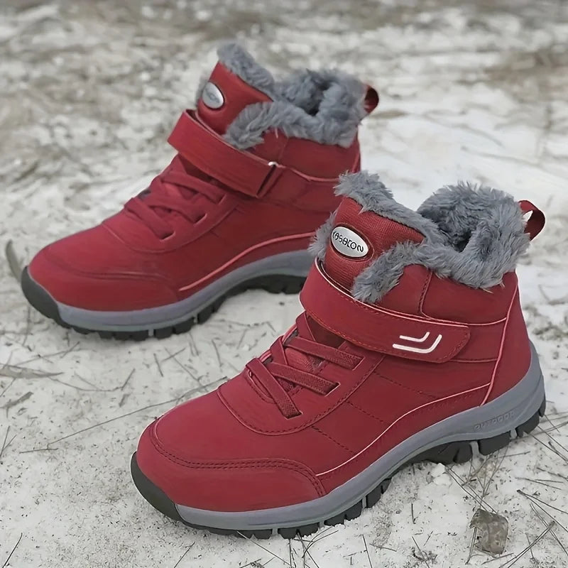 Red winter snow boots with plush lining, hook-and-loop strap, and grippy rubber sole
