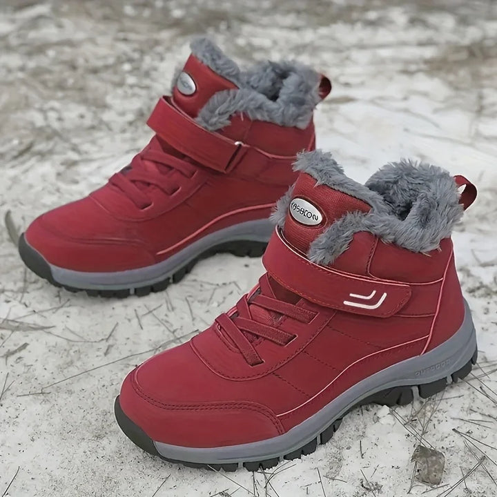 Red winter snow boots with plush lining, hook-and-loop strap, and grippy rubber sole