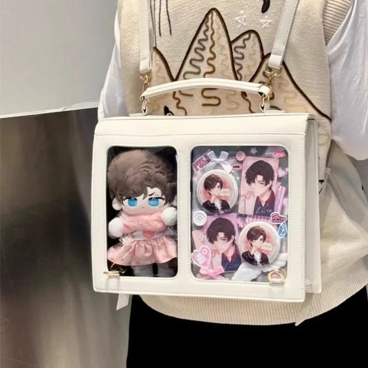 White crossbody bag with transparent window front and character badges