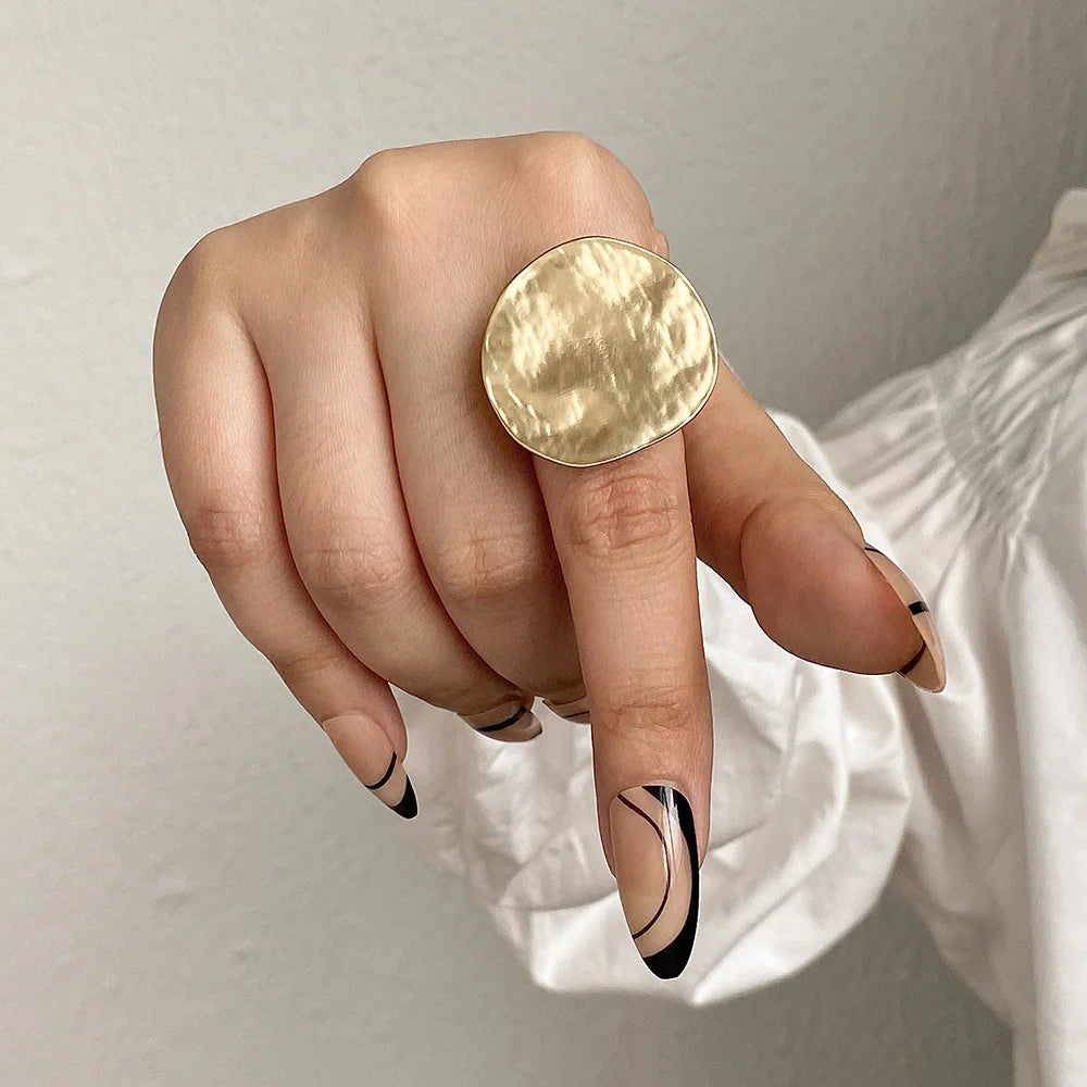 Gold round statement ring with textured disc top, adjustable open band